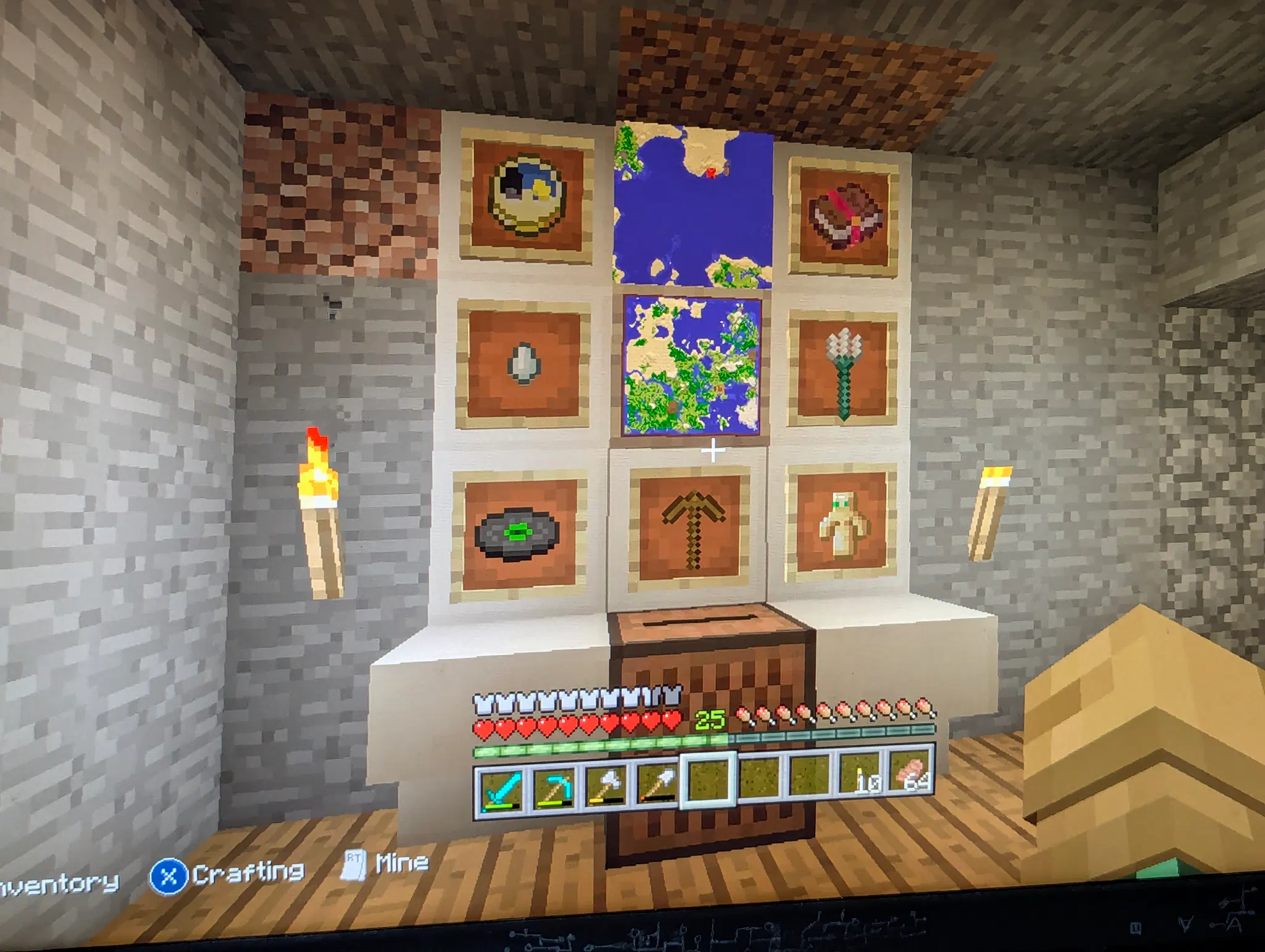 9 item frames on a quartz pedestal. There's a music disc, totem of undying, two maps, a wooden pickaxe, trident, ghast tear, clock and enchanted book in the frames, and below it a jukebox.